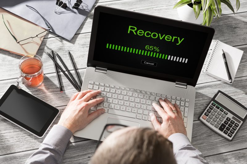 Picture of a laptop with the word recovery on the screen